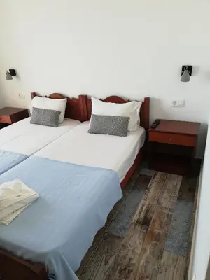 two beds sitting next to each other in a room at Maria's Hotel in Palaiochóra