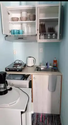 a small kitchen with a sink and a counter at Maria's Hotel in Palaiochóra