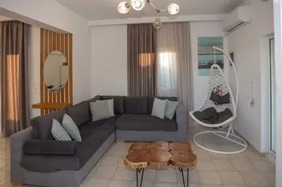 a living room with a couch and a chair at Notos Villas in Frangokastello