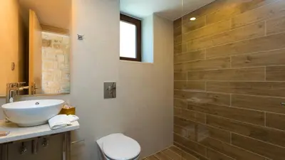 a bathroom with a sink and a toilet and a shower at Villa Emilia I Luxury, amazing seaview, next to the town in Kissamos