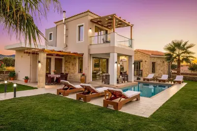 a villa with a swimming pool and a house at Villa Alexandros in Nopíyia