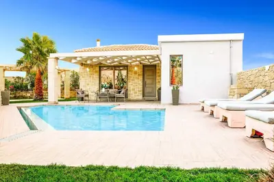 a villa with a swimming pool and a house at Villa Elenitsa in Nopíyia