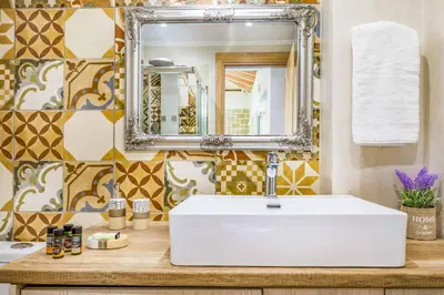 a bathroom with a white sink and a mirror at Villa Elenitsa in Nopíyia