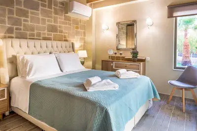 a bedroom with a bed with towels on it at Villa Elenitsa in Nopíyia