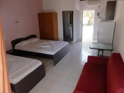 a living room with two beds and a couch at Ledakis Studios in Frangokastello