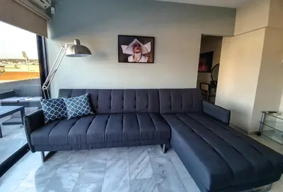 a black couch in a living room with a lamp at Sigma city loft, in the heart of Chania in Chania Town