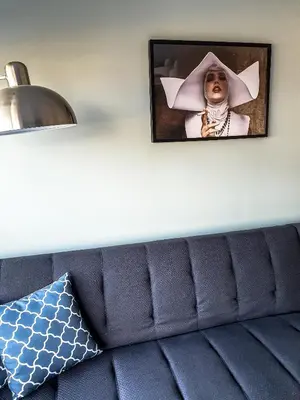 a picture of a woman in a witch hat on a wall at Sigma city loft, in the heart of Chania in Chania Town