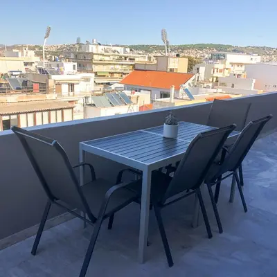 a table and chairs on a balcony with a view at Sigma city loft, in the heart of Chania in Chania Town