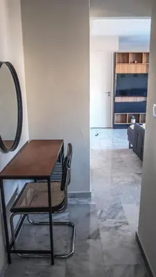 a table and a chair in a room at Sigma city loft, in the heart of Chania in Chania Town