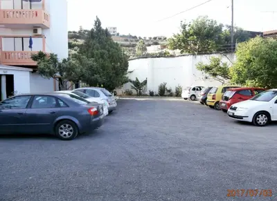 a bunch of cars parked in a parking lot at Pentari in Stalos