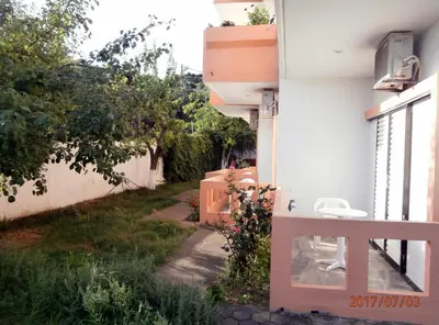 a balcony of a house with a table and chairs at Pentari in Stalos