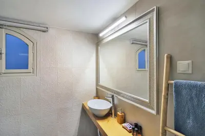 a bathroom with a sink and a mirror at Thalassa mou Seafront suite in Chania Town