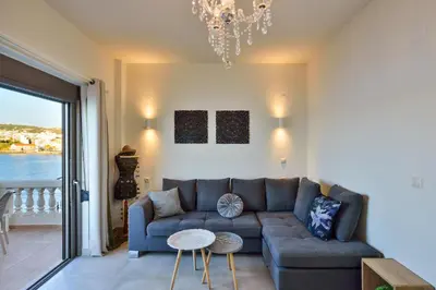 a living room with a couch and a table at Thalassa mou Seafront suite in Chania Town