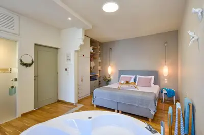 a bedroom with a bed and a tub in it at Thalassa mou Seafront suite in Chania Town