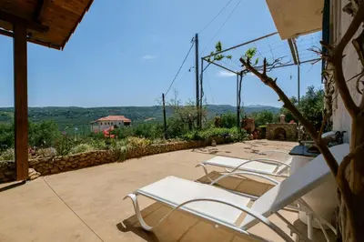 a group of lounge chairs sitting on a patio at Traditional Family Cretan Home! in Yerakianá