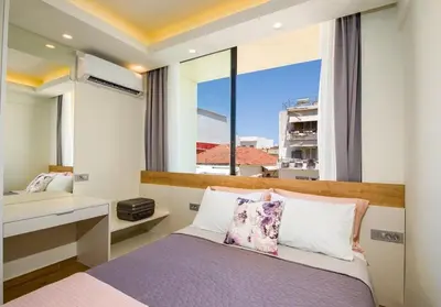 a bedroom with a bed and a large window at Modern Chic Studio - Chania City Center - Parking in Chania Town