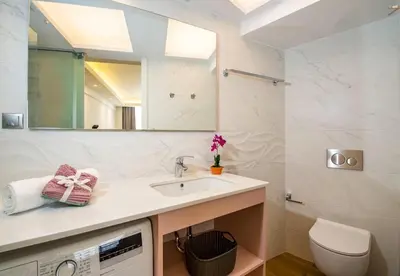 a bathroom with a sink and a toilet and a mirror at Modern Chic Studio - Chania City Center - Parking in Chania Town