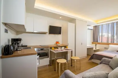 a small apartment with a kitchen and a bed at Modern Chic Studio - Chania City Center - Parking in Chania Town