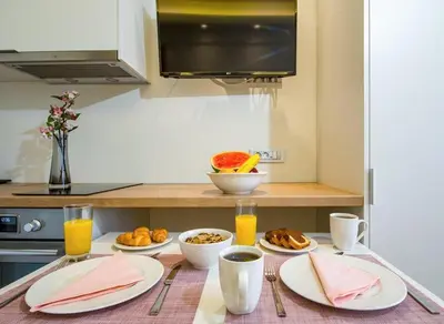 a table with plates of food on a kitchen counter at Modern Chic Studio - Chania City Center - Parking in Chania Town