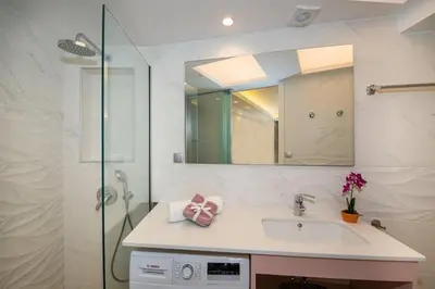 a bathroom with a sink and a shower with a mirror at Modern Chic Studio - Chania City Center - Parking in Chania Town