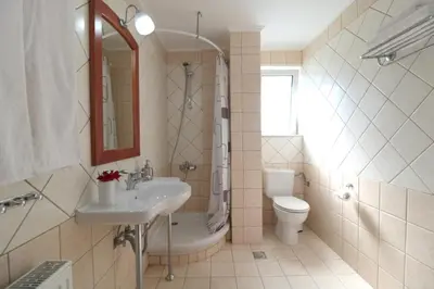 a bathroom with a sink and a toilet and a shower at Kalimera Apartments in Vamos