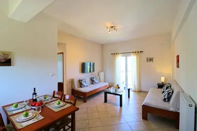 a living room with a couch and a table at Kalimera Apartments in Vamos