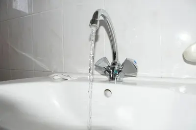 a bath tub with water coming out of a faucet at Litinas Apartments with pool in Agia Marina Nea Kydonias