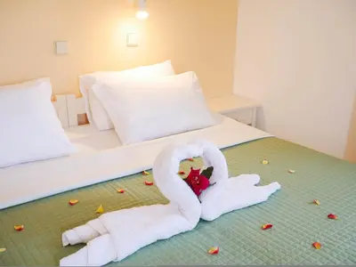 a bed with two swans made out of towels at Litinas Apartments with pool in Agia Marina Nea Kydonias