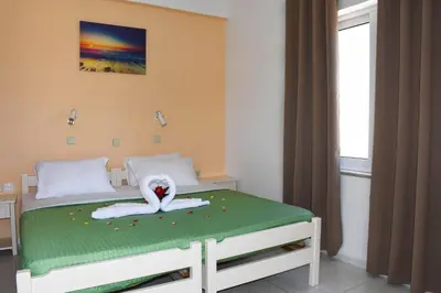 a bedroom with a bed with a swan on it at Litinas Apartments with pool in Agia Marina Nea Kydonias
