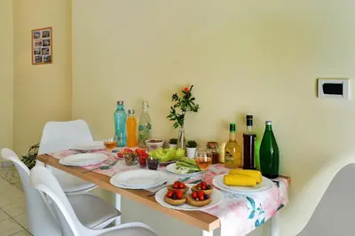 a table with plates of food and wine bottles at Sweet Home Lena Feel like home in Chania Town