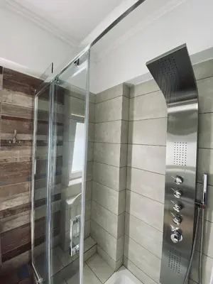 a shower with a glass door in a bathroom at Golden Victory in Agia Marina Nea Kydonias