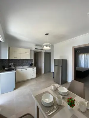 a kitchen with a table with plates and bowls on it at Golden Victory in Agia Marina Nea Kydonias