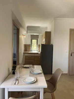 a table with plates and glasses on it in a kitchen at Golden Victory in Agia Marina Nea Kydonias