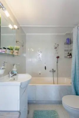 a bathroom with a tub and a sink and a toilet at Ocean Breeze Apartments in Gerani Chanion