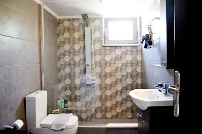 a bathroom with a shower and a toilet and a sink at Ocean Breeze Apartments in Gerani Chanion