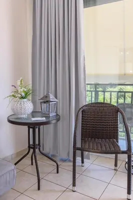 a table and a chair in a room with a window at Voula's Place in Chania Town