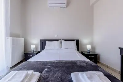 a bedroom with a large bed with two night stands at Voula's Place in Chania Town