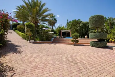 a brick walkway with a house in the background at Villa Elina Luxury Residence in Stalos