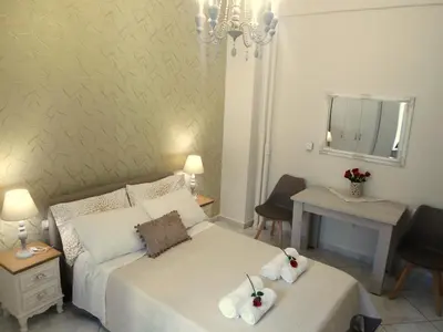 a bedroom with a bed with two towels on it at Meryland in Chania Town
