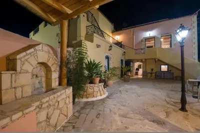 a courtyard of a house with a street light at Skandalis Apartments with pool in Chorafakia