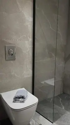 a bathroom with a toilet and a glass shower at Mesohori studios in Sfakiá