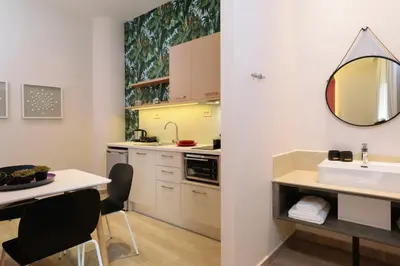 a kitchen with a sink and a table and chairs at Iliana Apartments in Falasarna
