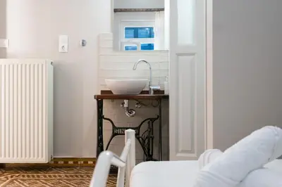 a bathroom with a sink on a small table at Grandma's Chic Home in Chania Venetian Harbor in Chania Town