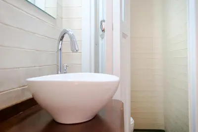 a white sink in a bathroom with a window at Grandma's Chic Home in Chania Venetian Harbor in Chania Town