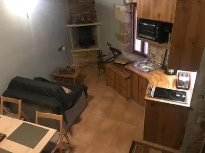 a living room with a couch and a kitchen at Aristokosmos in Chania Town
