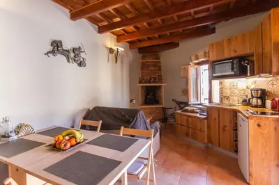 a kitchen with a table with a bowl of fruit on it at Aristokosmos in Chania Town