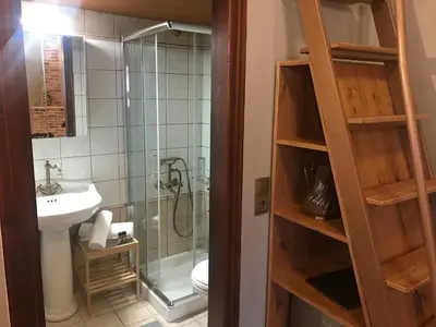 a bathroom with a shower and a toilet and a sink at Aristokosmos in Chania Town