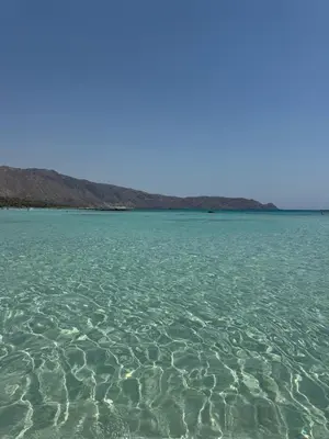 a large body of water with rocks in the background at Elafonisi Villa above the Beach in Elafonisi
