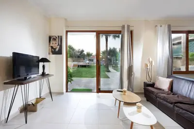 a living room with a couch and a tv at Chania Green House 1 in SFakianalíon