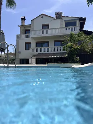 a house with a swimming pool in front of a building at Chania Green House 1 in SFakianalíon